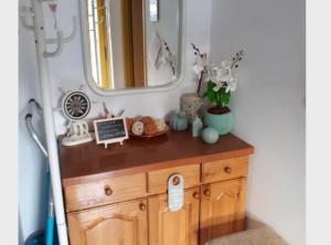 a dresser in a room with a mirror at Apartment Dijana in Bakar