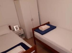 a small room with two beds and a mirror at Apartment Dijana in Bakar