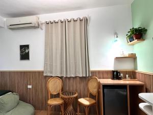 a kitchen with chairs and a table and a curtain at Beit Reihana in Dahab