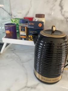 a pot sitting on a shelf with some food at Garden view Cosy Single Room in Derby
