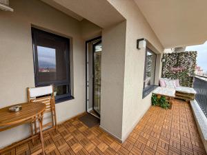a balcony with a table and chairs on a building at Mountain and City View with Underground Parking in Braşov
