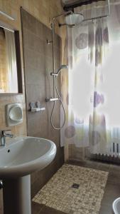 a bathroom with a sink and a shower at Casa Kendra in Montegrotto Terme +17 photos