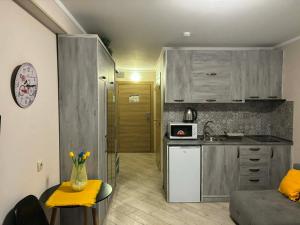 a kitchen with a counter and a kitchen with a microwave at Orbi Palace Bakuriani in Bakuriani