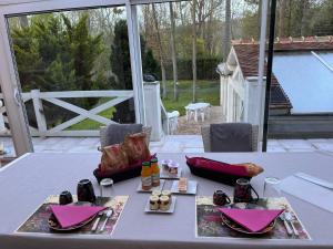 a table with pink napkins and food on it at Rose Garden Mezzanine in Giverny