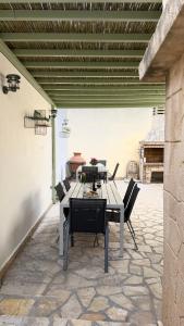 a table and chairs sitting on a patio at Central Suites Aegina 5 in Egina