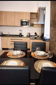 a kitchen with two tables with wine glasses on them at Casa luz e conforto-Casa 20 in Almancil