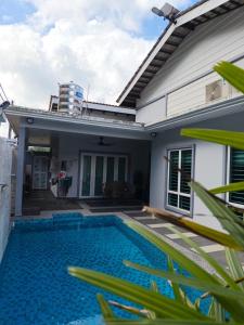 a swimming pool in the backyard of a house at Homestay with pool kuantan in Kuantan