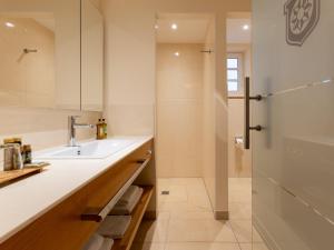 a bathroom with a sink and a shower at Gutshotel Odelzhausen in Odelzhausen