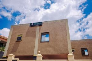 a building with a sign on the side of it at Hulcity valley hotel in Kampala