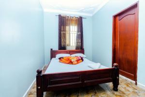 a bedroom with a bed in a blue room at Hulcity valley hotel in Kampala