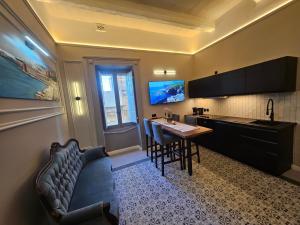 a kitchen with a couch and a table in a room at Portus Noir Valletta in Valletta