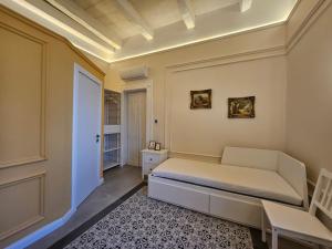 a bedroom with a bed and a table in it at Portus Noir Valletta in Valletta