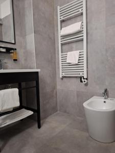 a bathroom with a sink and a tub and a mirror at Orzihotel in Orzivecchi