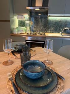 a table with a bowl and two wine glasses on it at Villa Montepaone in Montepaone Lido