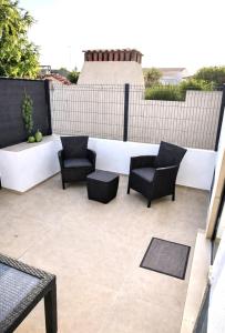 a patio with chairs and tables on a building at Casa luz e conforto-Casa 20 in Almancil +3 photos