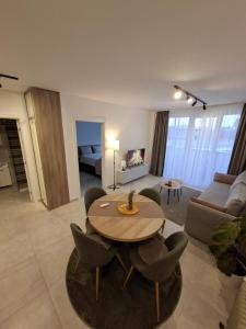 a living room with a table and chairs and a couch at Silver 2 & SPA in Veliko Gradište +31 photos