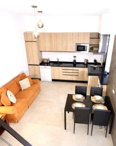 a living room with a couch and a table at Casa luz e conforto-Casa 20 in Almancil