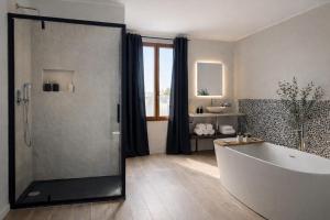 a large bathroom with a tub and a shower at Elisir in Bergamo +63 photos