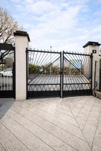 a black gate with a driveway at Elisir in Bergamo