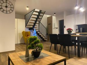 a living room and dining room with a spiral staircase at Leśna Przystań Kaszuby in JeleÅ„ska Huta