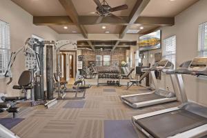 a gym with treadmills and cardio equipment in a room at Landing Spectacular 1BD Pool Courtyard in Broken Arrow