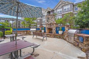 a patio with a grill and a picnic table at Landing Spectacular 1BD Pool Courtyard in Broken Arrow