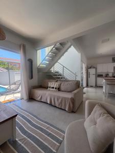 a bedroom with a large bed and a staircase at Casa beira Mar in Itanhaém