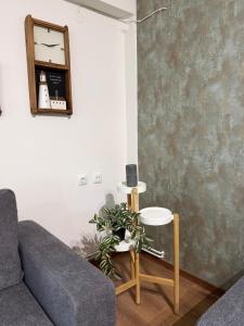 a living room with a couch and a clock on the wall at Mary's Pool Apartment in Perea
