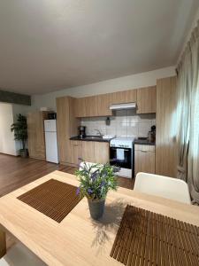 a kitchen with a wooden table in a room at Mary's Pool Apartment in Perea