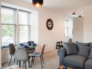 a living room with a couch and a table at Liquorstane - Uk40568 in Falkland