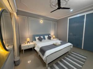 a bedroom with a bed and a ceiling fan at Maison Royale House 3bhk apartment in Jaipur