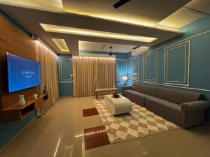 a living room with a couch and a tv at Maison Royale House 3bhk apartment in Jaipur