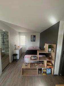 a bedroom with a bed and a table at CARQUEIRANNE STUDIO DE CHARME PROCHE PLAGES in Carqueiranne
