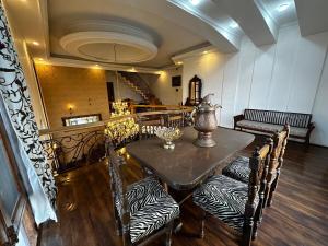 a dining room with a table and chairs at The Landing Nest - Villa in Srinagar