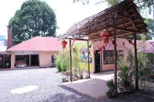 a building with a thatched roof in front of a street at Hotel near the clock tower in Arusha
