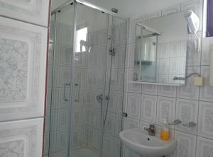 a bathroom with a shower and a sink at Beachfront Sunset Apartments Sutomore in Brca +50 photos