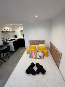 a living room with a couch with shoes on the floor at studio indépendant dans une villa in Aimargues