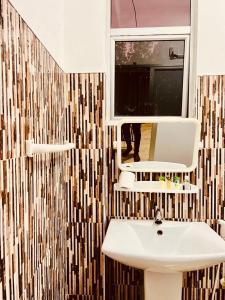a bathroom with a sink and a mirror at Atrium Cottage in Seeduwa +40 photos