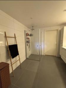 a bathroom with a shower and a glass door at Etterstad in Oslo
