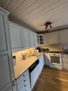 a kitchen with white cabinets and a counter top at Etterstad in Oslo