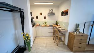 a kitchen with a counter and a table in it at Malu Apartman in Sárvár