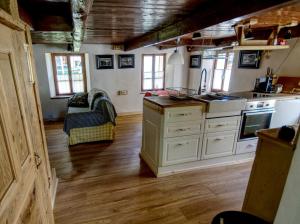a kitchen with white cabinets and a counter top at Stones and Pines in Rimella