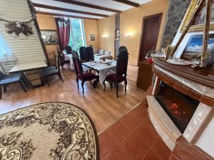 a living room with a table and a fireplace at Hotel palas tatariv in Tatariv
