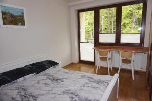 a bedroom with a bed and a table and chairs at NOCLEGI Święta Katarzyna CENTRUM in Święta Katarzyna