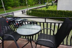 a table and chairs sitting on a balcony at NOCLEGI Święta Katarzyna CENTRUM in Święta Katarzyna