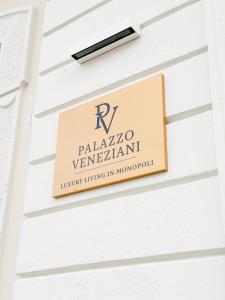 a sign on the side of a building at Palazzo Veneziani - Luxury Living in Monopoli in Monopoli