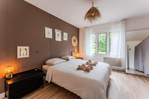 a bedroom with two beds and a window at Le Chalet de la Leyre in Le Teich