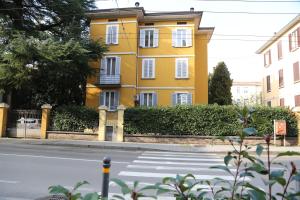 a yellow building on the side of a street at La Gardenia del ducato in Parma