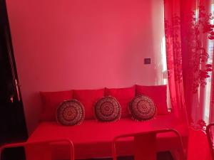 a red room with a red couch with red pillows at Apartments Vesna Luxury & Stefan Ap 10 in Paralia Katerinis
