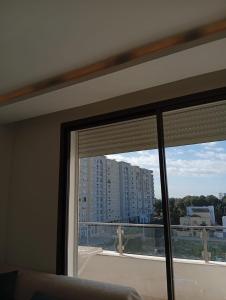 a window in a room with a view of a building at Apartment cosy in Sidi Daoud
